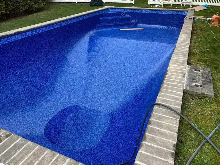Blue patterned pool finish edged with bluestone coping